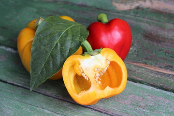 Multi-colored bell peppers on the background of boards