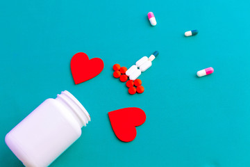 symbol made out of medical red capsules and white tablets