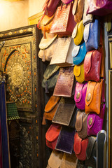 Leather handbags in the shop of a merchant in the souk of the medina of Fes in Morocco