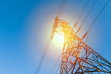 power transmission line with sun light for background