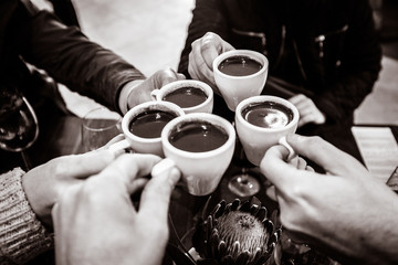 Fototapeta na wymiar Chocolate in a cup. Friends sharing a sweet chocolate drink. Friends together in a restaurant. Black and white. Sepia.