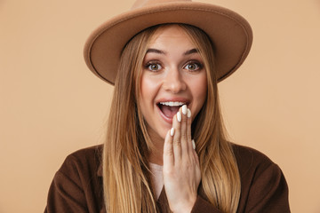 Image of young caucasian girl wearing hat and coat expressing wonder