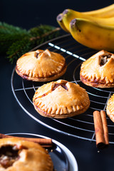 Food concept fresh baked Homemade Banana foster hand pie on black background