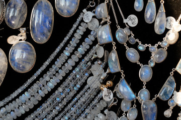 Rainbow moonstone necklage earrings jewelry on display stand in a shop market - obrazy, fototapety, plakaty