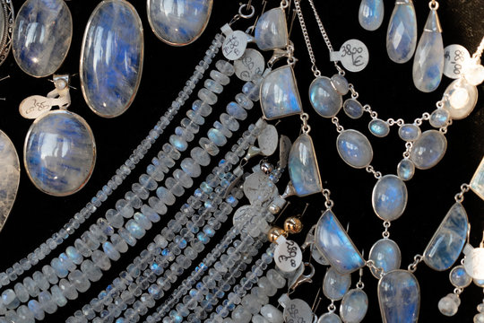 Rainbow moonstone necklage earrings jewelry on display stand in a shop market