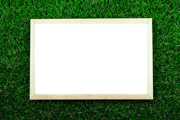 A white picture frame on a green grass