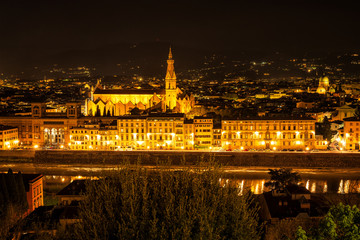 Florence, Italy - April 7, 2019: Amazing night view of Florence city, Italy with the river Arno and Basilica of Santa Croce.