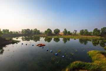 Blurred abstract background of nature, panoramic views in natural marshes, with small boats (kayaks) for fish to survive, with clear skies during the day