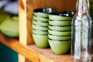 Closeup of bowls on shelf in restaurant prepared for serving