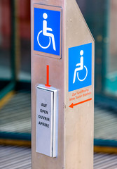 disabled sign at a door opener