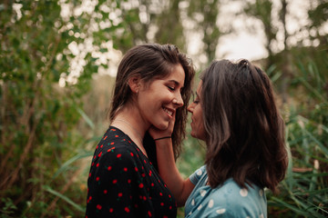 Fototapeta premium Two young women embraced on the field