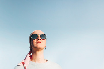 woman with pink headscarf, has cancer
