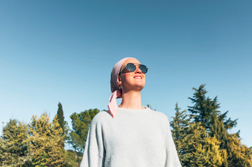 woman with pink headscarf, has cancer