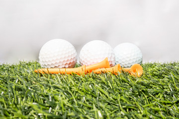 The golf ball is placed on a green artificial grass. It means getting ready to play golf