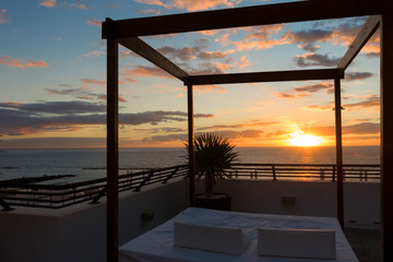 beautiful sunset at a resort with an outdoor bed