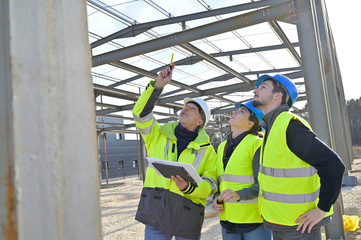 Engineering instructor working on building site with apprentice