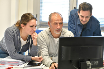 Young people in design office with instructor