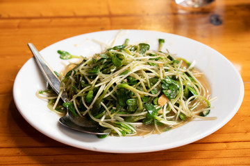 Fried sunflower sprout on white dish background