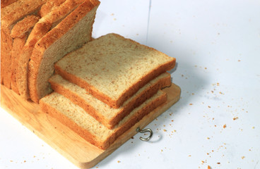 Close up image of cut of loaf bread on white against white background