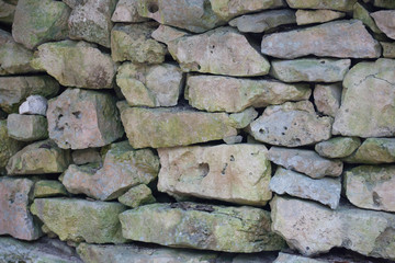 Rough weathered ancient mayan stone  wall surface texture close up