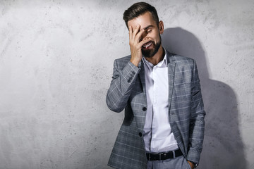 Handsome bearded man wearing gray checkered suit
