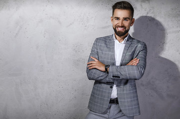 Handsome bearded man wearing gray checkered suit