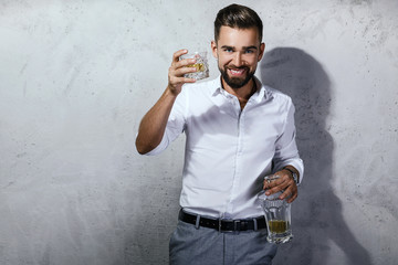 Handsome bearded man with a glass of whiskey
