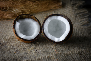 Fresh coconut on jute background
