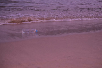 Plastic scraps left over by people on the beach in the evening. Is what causes environmental problems