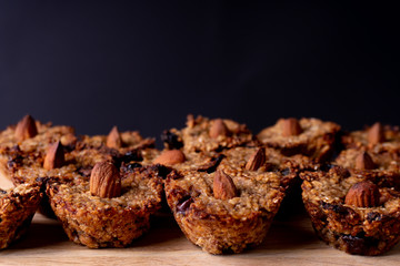 Homemade vegan cookies made of oats, banana and chocolate. Decorated with an almond. Cookie pattern.