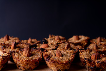 Homemade vegan cookies made of oats, banana and chocolate. Decorated with an almond. Cookie pattern.