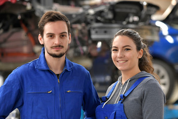 Apprentice working in automobile workshop