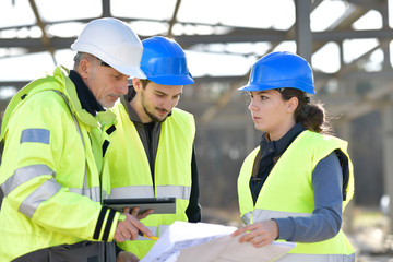 Apprentices with instructor on building site