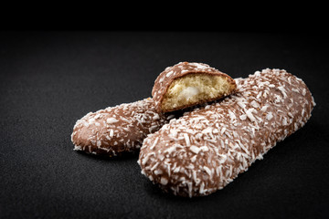 Chocolate cookies with coconut on black background.