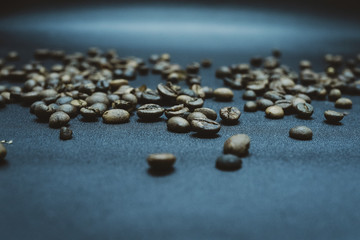 Fototapeta na wymiar Photo of roasted coffee beans on black background. Arabica robusta bean. Macro. Coffee bean spread. Image
