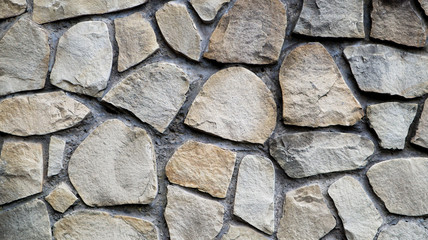The texture of the stone wall. Old castle stone wall texture background. Stone wall as a background or texture. Part of a stone wall, for background or texture. pattern gray color modern style design