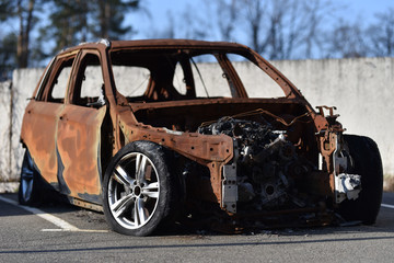 burnt car hatchback in the parking lot