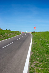 Empty road in countryside with speed limit sign