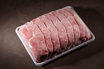 Frozen shabu shabu meat on black background