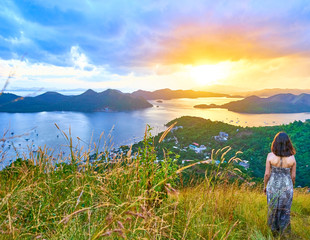 Brunette Woman looking at view from Mount Tapyas on Coron Island - North Palawan, Philippines....