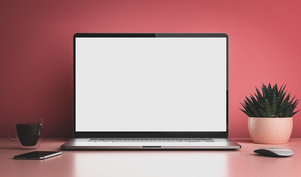 Laptop with blank screen on white table with mouse and smartphone. Home interior on minimalistic pink color background