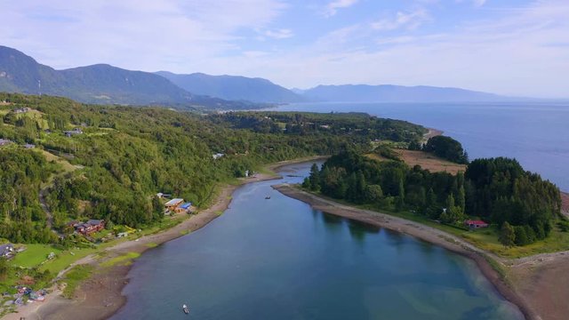 Aerial view of beautiful landscape along the coastal edge during low tide, native forests and mountains