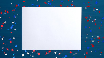 Blank paper card on blue background with confetti stars in American flag colors. Flat lay, top view, copy space. Happy Presidents Day, USA Independence Day, Labor or Memorial Day, US election concept