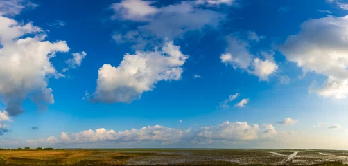 Foto op Canvas Panorama of a beautiful blue sky filled with white clouds over the big lake at Thale Noi Waterfowl Reserve nonihunting area , the famous for its attractions in Thailand. © Narupon