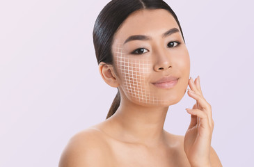 Portrait of beautiful asian woman touching face over grey background