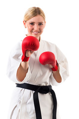 Girl in kimono for karate and boxing gloves