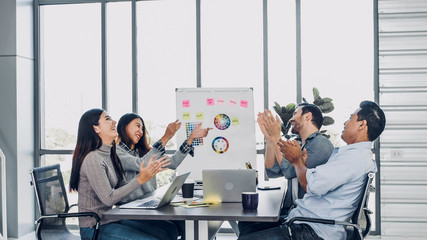 diversity creative designer applaud for job success at meeting table at modern office after finish presentation to client.teamwork concept