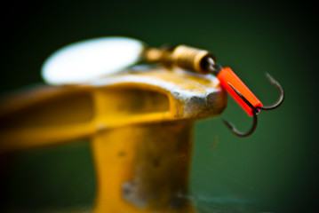Naklejka premium Fishing hook placed on a metal object on a summer day.