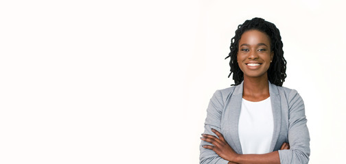 Confident afro businesswoman posing with folded arms on white background