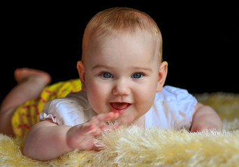 Cute smiling happy baby in the bedroom.
